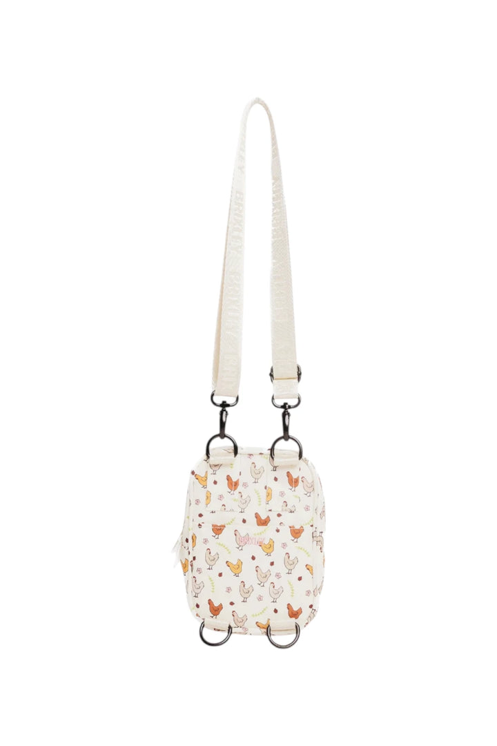 A small cream-colored crossbody bag with a delicate chicken pattern in orange, brown, and green, featuring a matching cream shoulder strap and black metal hardware.