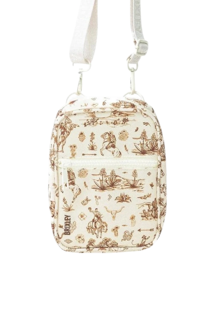 A small crossbody bag with a cream background and a brown western pattern, featuring a white shoulder strap and silver metal hardware.