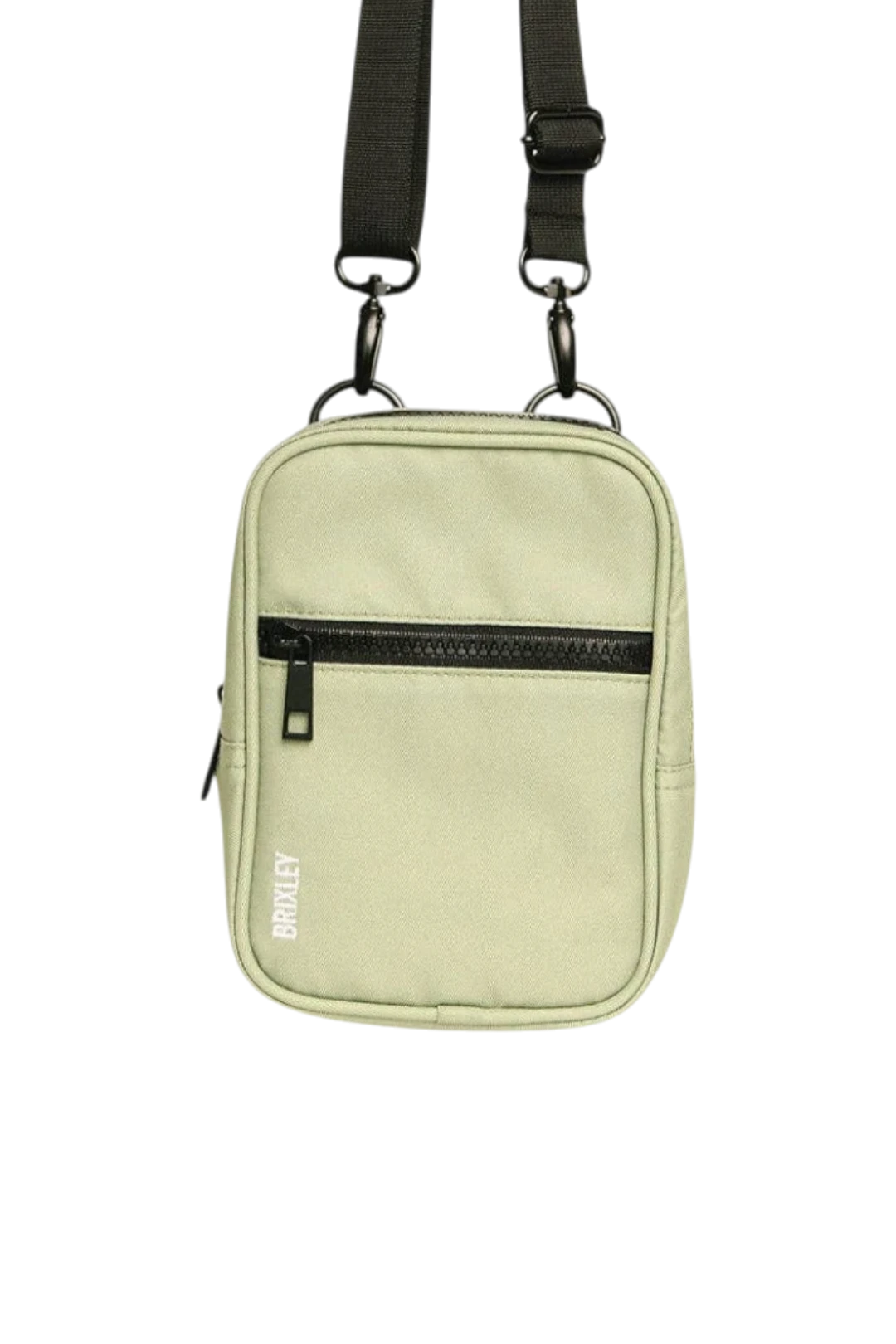 A light sage green crossbody bag with a black zipper, black adjustable strap, and black hardware, featuring the brand name 'BRIXLEY' printed vertically on the front.