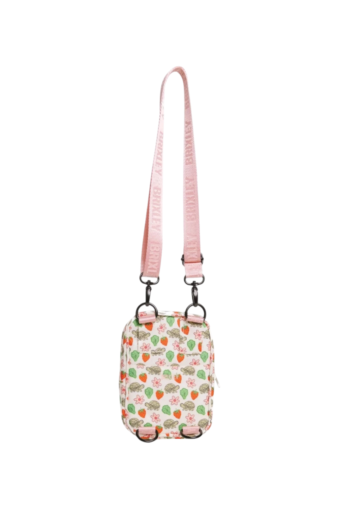 A small crossbody bag with a pink strap and a white body covered in a strawberry and green leaf pattern, shown against a plain white background.