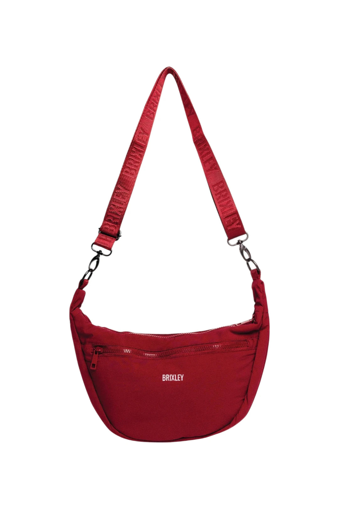 A red Brixley crossbody bag with an adjustable shoulder strap and a front zippered pocket, shown against a plain white background.