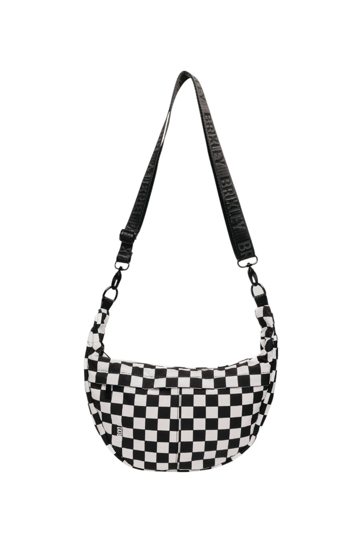 A black and white checkered crescent shoulder bag with a wide black strap featuring white text, shown against a plain white background.