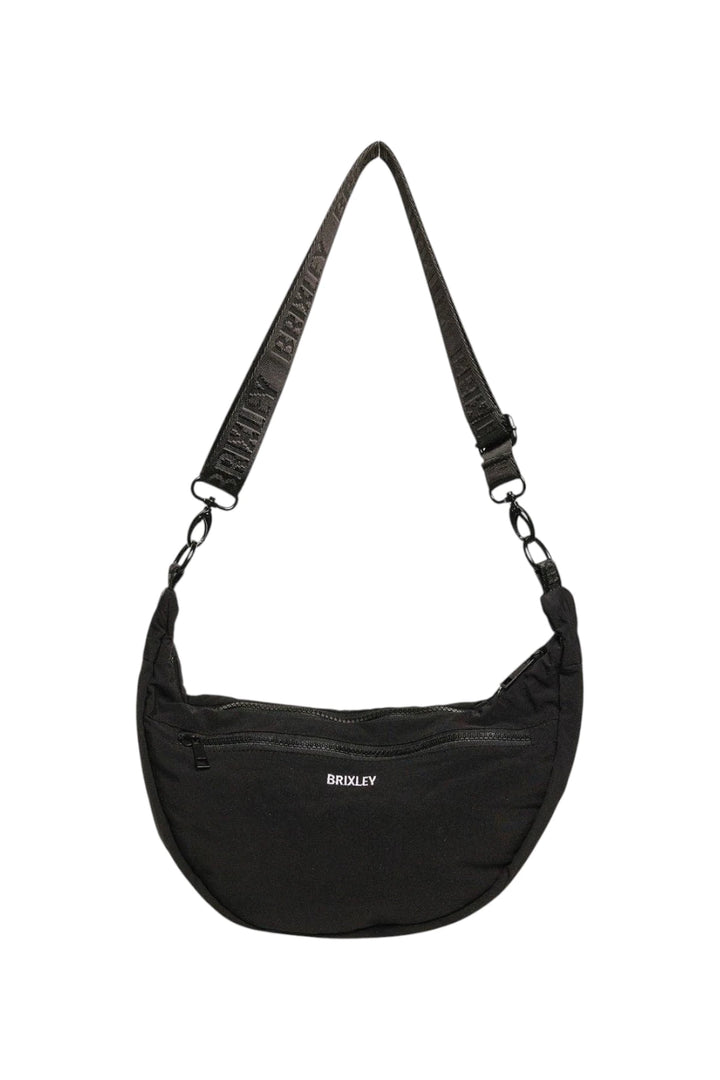 A black crescent-shaped shoulder bag with a wide, patterned black strap and a small white 'BRIXLEY' logo on the front, shown against a plain white background.