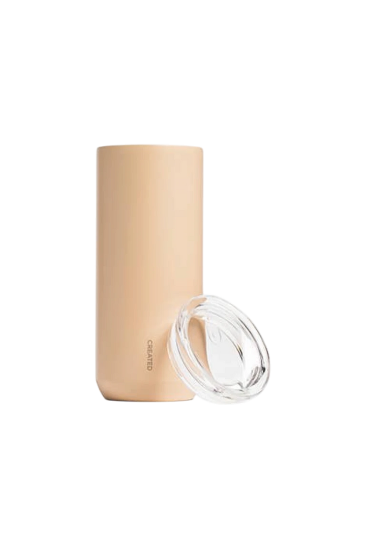 A matte beige insulated tumbler with a clear plastic lid, shown on a solid white background.