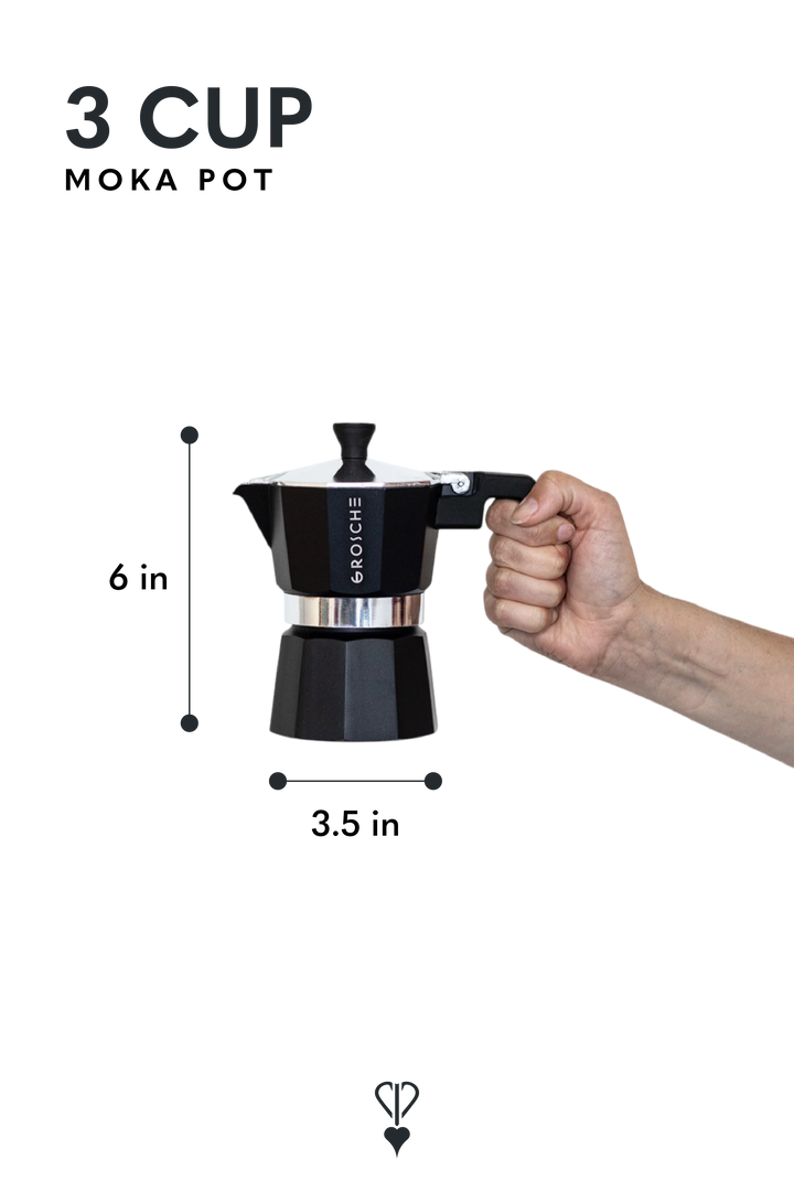 A black 3-cup moka pot with dimension labels showing 6 inches tall and 3.5 inches wide, with a hand holding the handle on the right.